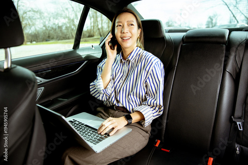 Korean woman works on lapto...