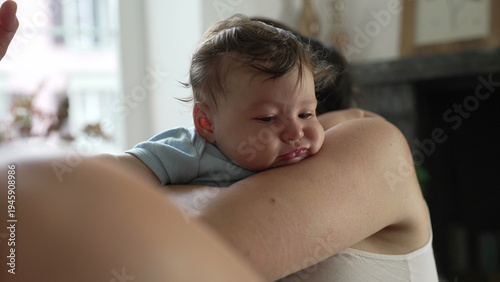 Free Download Baby resting on mother’s shoulder, calm expression, feeling secure, quiet bonding, nurturing touch, tender moment, intimate connection, love and protection - GFXLoad