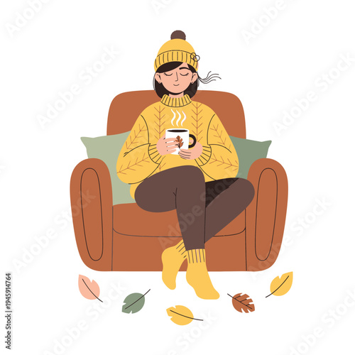 Cozy woman in yellow sweater and hat enjoying hot drink in armchair, autumn leaves