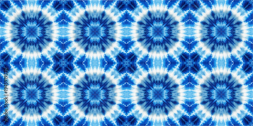 Blue indigo shibori tie dye seamless pattern inspired by traditional Japanese textile techniques. Radial geometric ornament with watercolor effect