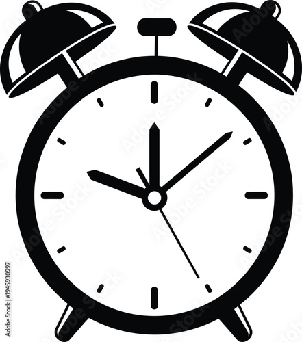 Classic alarm clock with hands pointing to ten minutes past three