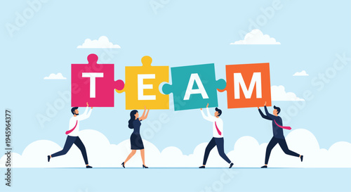 Energetic group of diverse business professionals carrying large colorful jigsaw puzzle pieces that spell out the word TEAM.