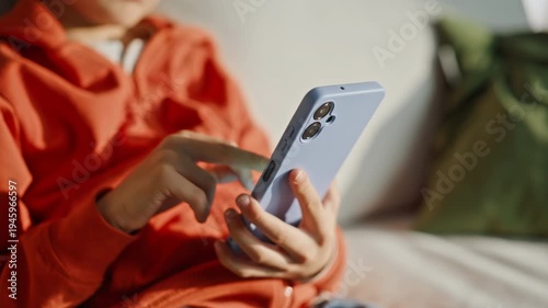 Boy hands scrolling smartphone sitting couch closeup. Relaxed child browsing