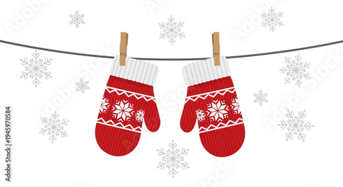 Pair of red knitted mittens with snowflake patterns hanging on a clothesline in winter, isolated white background. Cozy winter gloves with folk ornament.