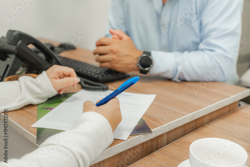 Client signing funeral services contract with consultant