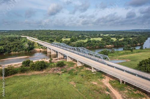 Obraz na plátně Empty Bridge With Road Over the Brazos River and Surrounding Green Landscape  in