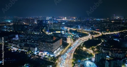 Wallpaper Mural Aerial view of heavy vehicle traffic on illuminated city highway and modern skyscrapers at night in Nanjing, China. Torontodigital.ca