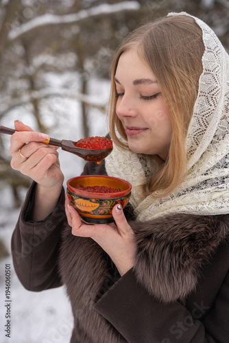 Quadro su tela Traditional winter snack with red caviar in a painted khokhloma bowl captures nostalgic taste and cozy mood