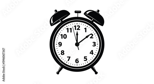 A classic black alarm clock displaying ten minutes past ten