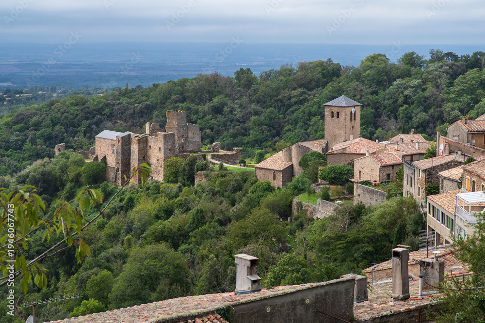 Naklejka premium Medieval castle, church and village of Saissac in France, surrounded by nature