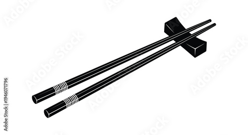 A pair of black chopsticks and a chopstick rest on a white background