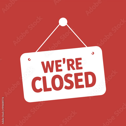 A white sign with red text that reads 'WE'RE CLOSED' hanging on a red background