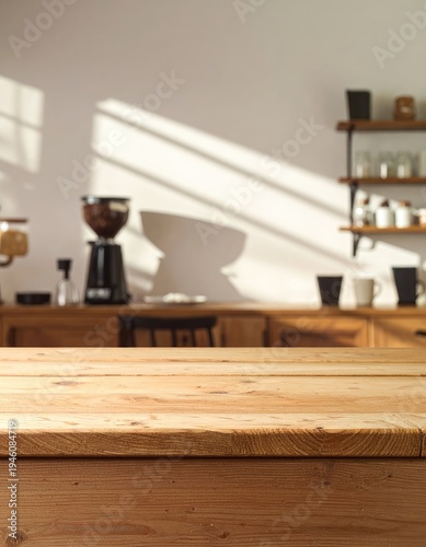 A warmly lit wooden surface sits in front of a blurred coffee shop interior, showcasing a coffee grinder and shelves filled with mugs, bathed in soft sunlight.