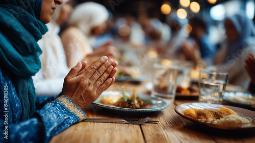 Family praying at restaurant table, religious observance moment, iftar time worship, spiritual dining gathering, blessing before meal, faceless family praying, defocused