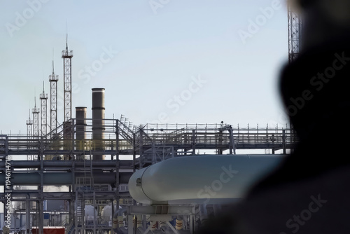 Oil worker view from back looking at gas oil equipment station
