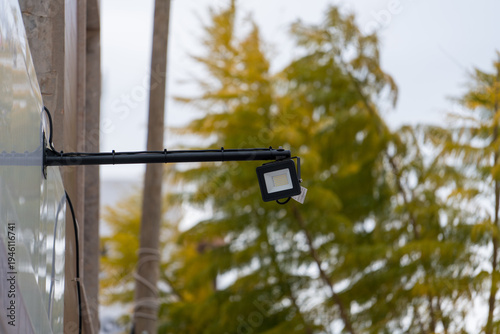 Slika na platnu Outdoor LED security floodlight mounted on building wall