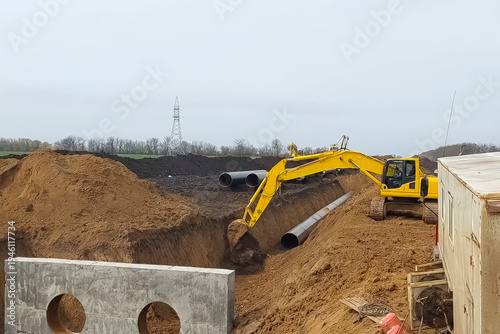 Excavators bury the laid gas pipeline.