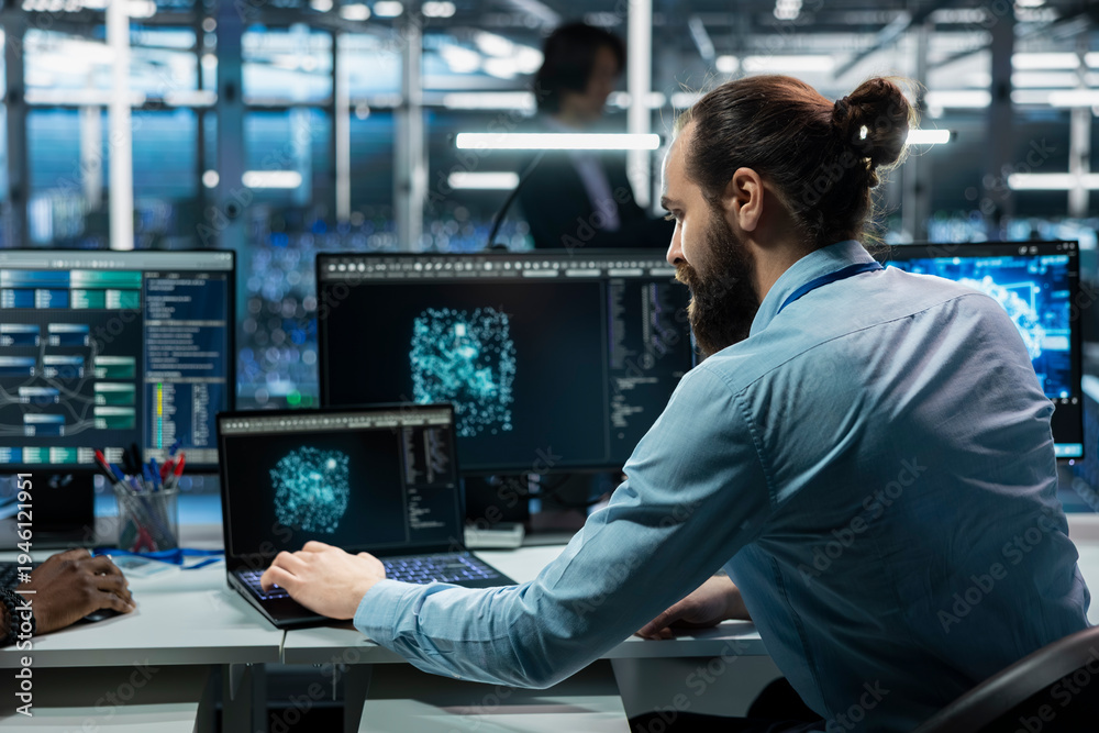 Fototapeta premium Data center software developer running simulations for AI driven forecasting, tracking performance. Server hub IT professional integrating artificial intelligence APIs into software platforms