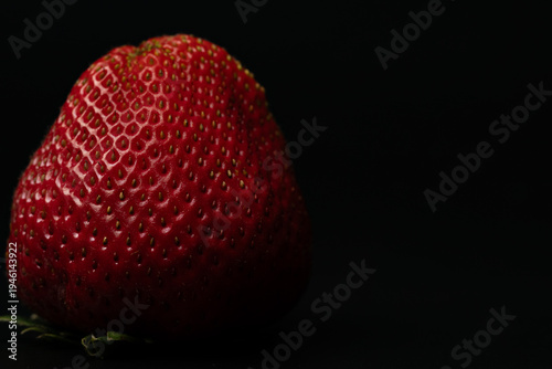 Fresh red strawberry on black background