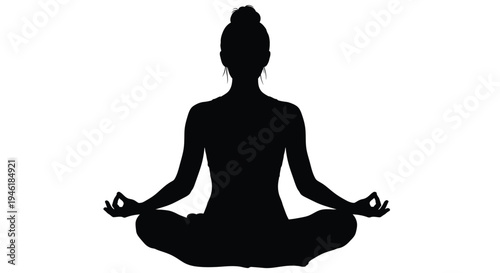Silhouette of a woman sitting in the lotus position practicing mindfulness and meditation exercises