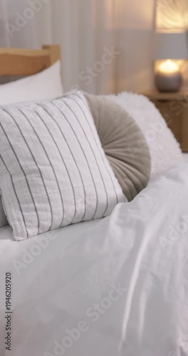 Comfortable bed with fresh cotton linens indoors, closeup