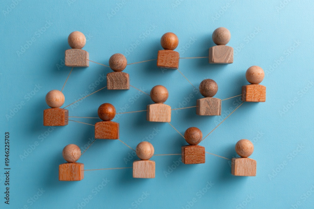 Obraz premium Interconnected Diversity: Wooden figures linked together, illustrating the bonds that tie a community, symbolizing unity and togetherness.