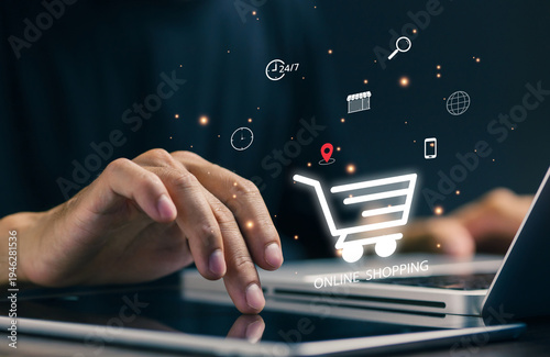 Person shopping online using laptop and tablet with digital shopping cart interface. Concept of e commerce, online purchase, digital payment, retail technology and modern online marketplace.