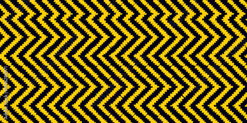 A striking black and yellow chevron pattern fills the entire frame