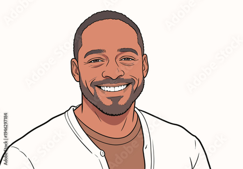 A man smiles while sitting indoors, wearing a white shirt and a brown top. The background is plain and unmarked.