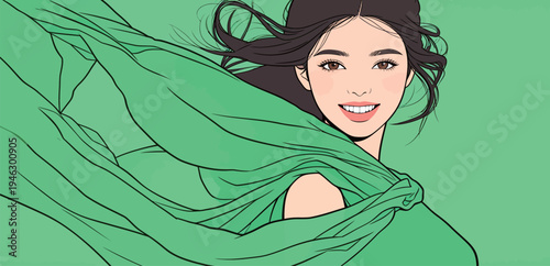A woman stands with flowing green fabric around her as wind moves it gently. She has long dark hair and a wide smile.