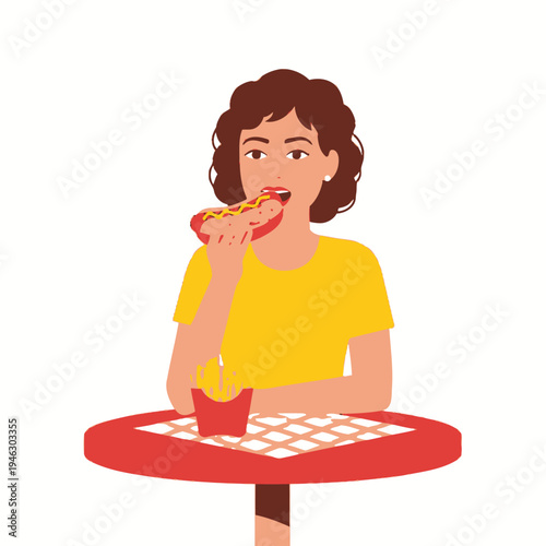 Woman eating hot dog and french fries at outdoor cafe table