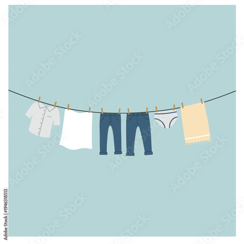 Clothes hanging on a line against a soft blue background, depicting a laundry scene