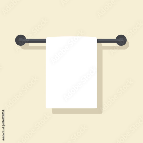 A clean white towel hanging on a modern towel rack against a light beige wall