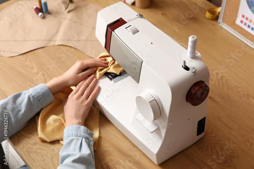 Female tailor's hands using...