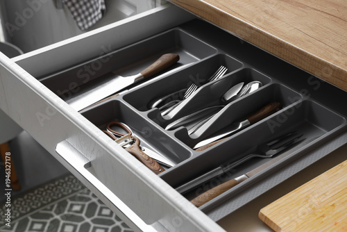 Open drawer with cutlery in...