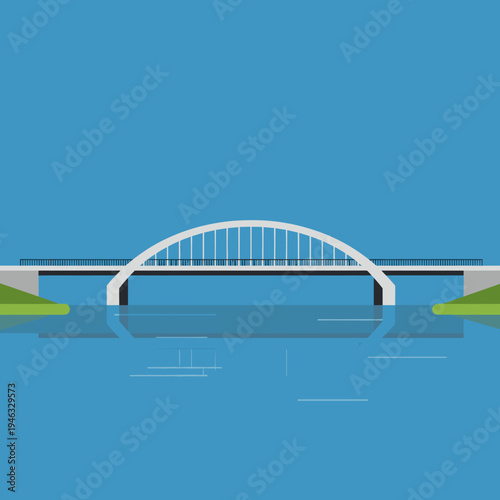 Modern arch bridge spanning a serene river beneath a clear blue sky