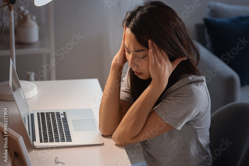Sad young Asian woman sitti...