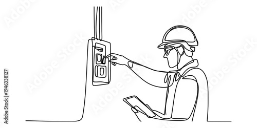 Worker in hard hat operating industrial control panel with clipboard
