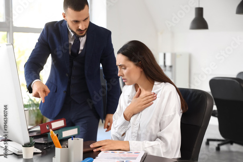 Angry male boss scolding fe...