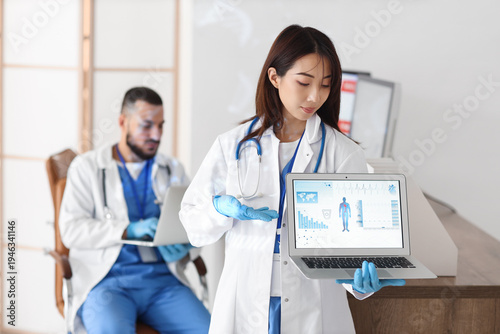 Female Asian doctor analyzi...