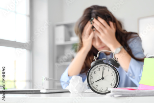 Tired young businesswoman w...