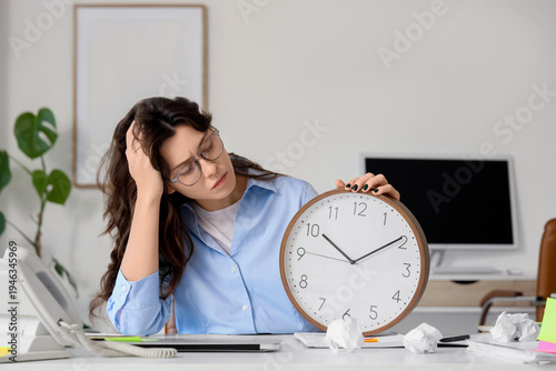 Tired young businesswoman w...