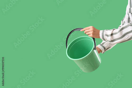 Woman with plastic bucket o...