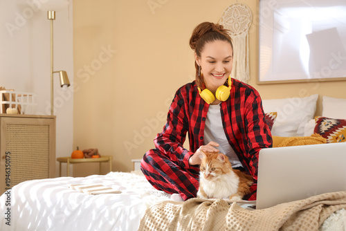 Young woman with cute cat a...
