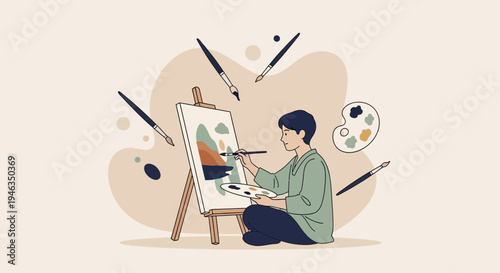 Young man painting on canvas board.