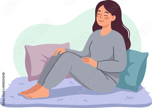 Woman sitting on bed with pillows in a cozy bedroom environment