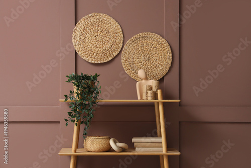 Wooden bookshelf with plant...