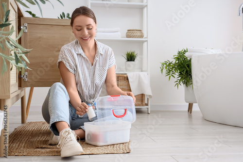 Young woman taking pill bot...