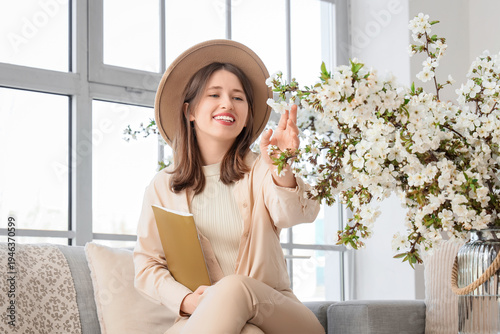 Young woman with magazine a...