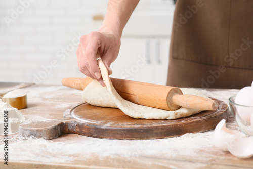 Woman rolling out fresh dou...
